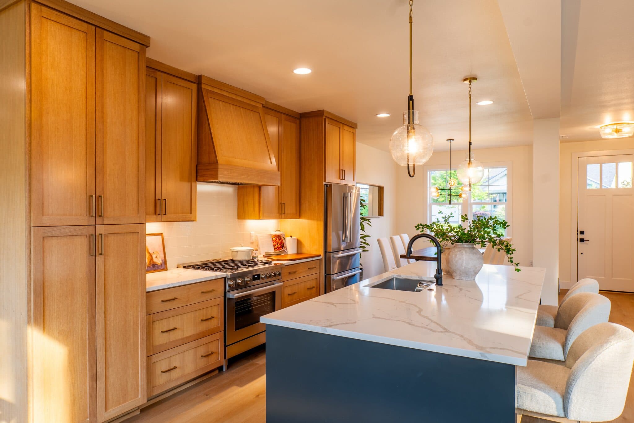 Kitchen with marble island and pendant lights — real estate photography by Hahn Media, Oregon
